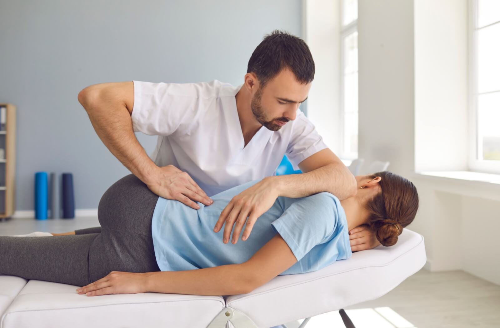 A patient receiving a chiropractic adjustment to help with sciatica pain