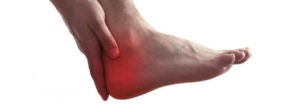 A person rubbing their heel in pain.