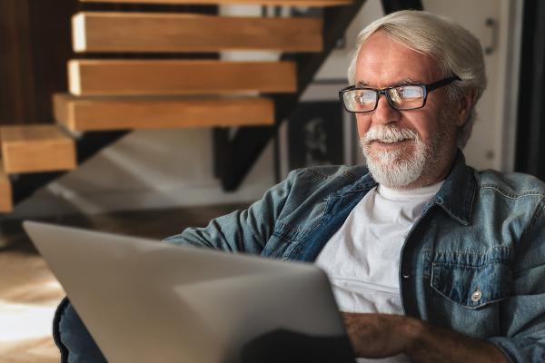 A main reading on his laptop.