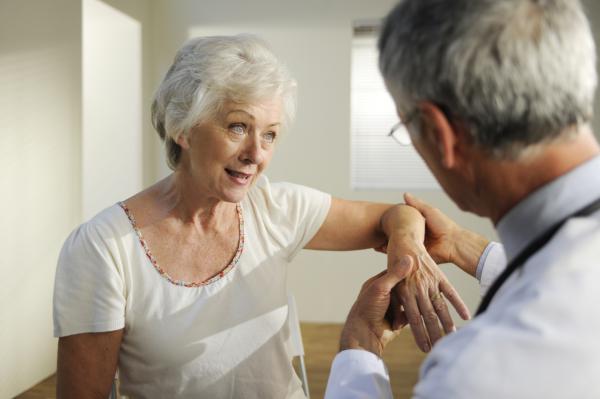 A woman having her arm examined.