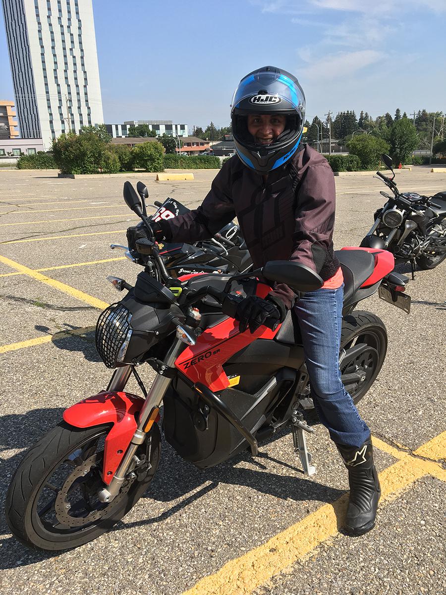 Dr. Alma Nenshi on a motorcycle.